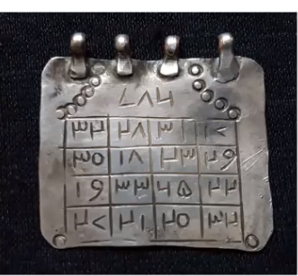 An example of a silver pendant with numbers in magic squares